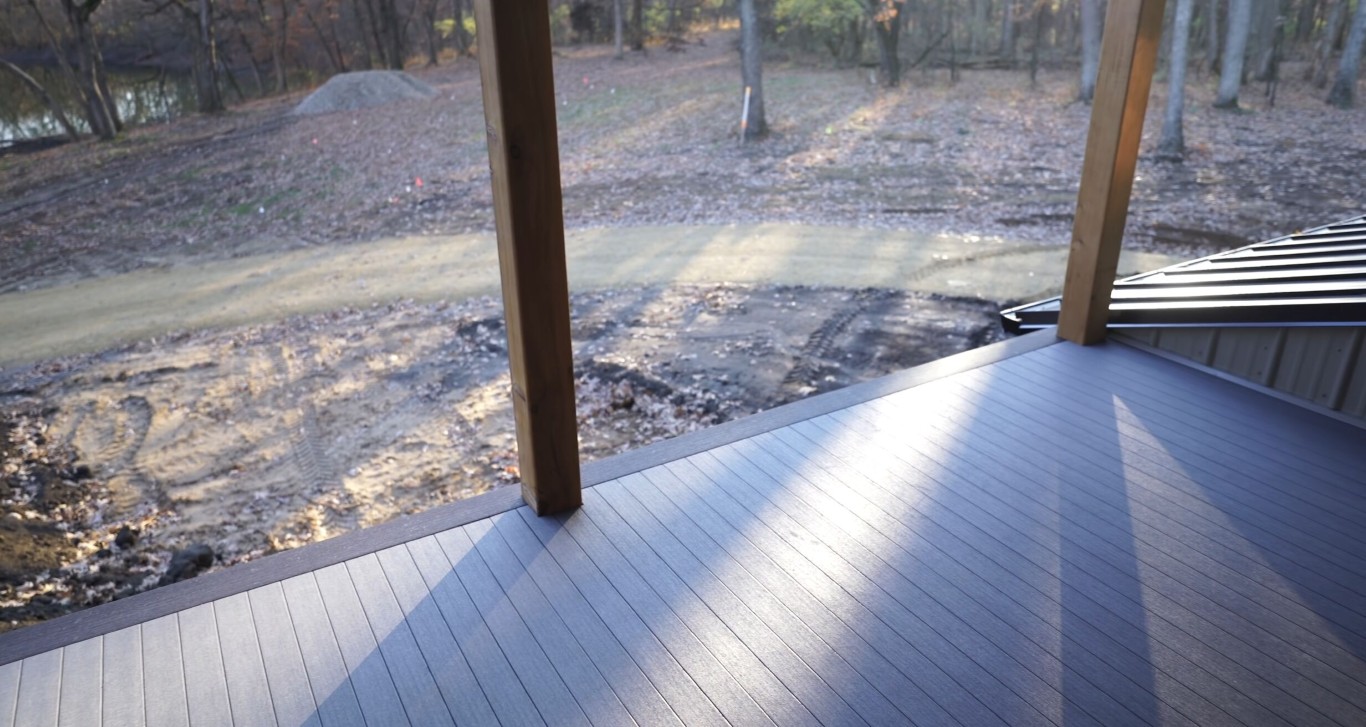 Weather-resistant deck construction with protective covering in progress