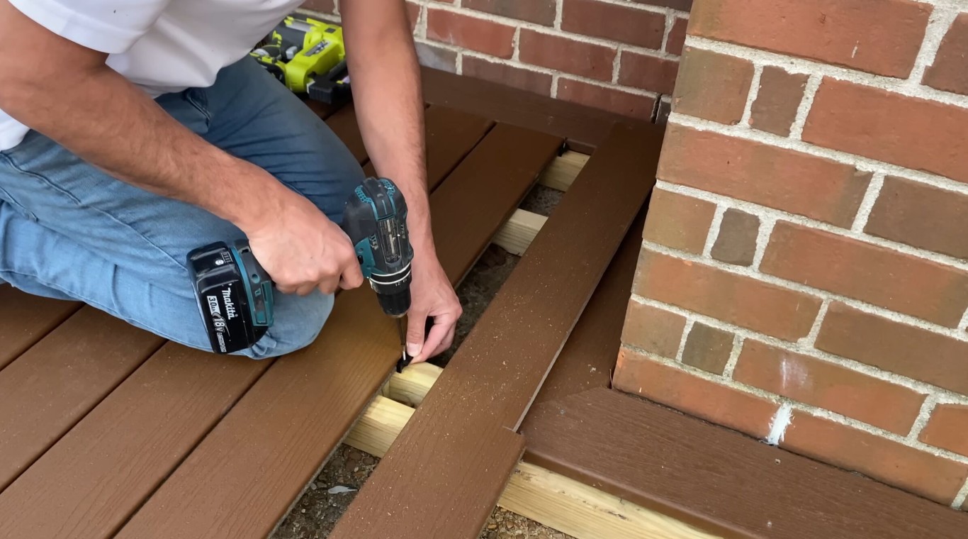 Professional deck builder installing composite boards with precision