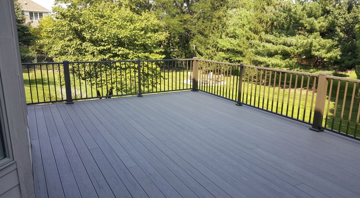 High-quality deck materials with modern gray composite boards and black vertical railings